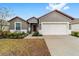 One story house with gray exterior, red door, and two-car garage at 7402 Sw 99Th Ave, Ocala, FL 34481