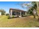 Single-story home with screened porch and landscaped yard at 7402 Sw 99Th Ave, Ocala, FL 34481