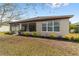 Single-story home with screened porch and landscaped yard at 7402 Sw 99Th Ave, Ocala, FL 34481