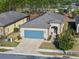 One-story house with gray garage door and paver driveway; aerial view at 7752 Sw 96Th Avenue Rd, Ocala, FL 34481