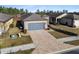 One-story house with gray garage door and paver driveway; aerial view at 7752 Sw 96Th Avenue Rd, Ocala, FL 34481