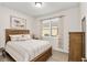 Bright bedroom with wood furniture and striped bedding at 7752 Sw 96Th Avenue Rd, Ocala, FL 34481