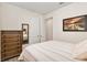 Guest bedroom with wood dresser and striped bedding at 7752 Sw 96Th Avenue Rd, Ocala, FL 34481