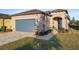 Tan one-story house with gray garage door, landscaped yard, and paver driveway at 7752 Sw 96Th Avenue Rd, Ocala, FL 34481