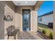 Front porch features a metal bench and custom signage at 7752 Sw 96Th Avenue Rd, Ocala, FL 34481