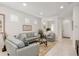 Bright living room with light gray sofas, glass coffee table, and entryway view at 7752 Sw 96Th Avenue Rd, Ocala, FL 34481