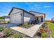 One-story house featuring a walkway, landscaping, and attached garage at 8332 Sw 54Th Loop, Ocala, FL 34481