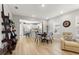 Open concept kitchen and dining area with light cabinets, island, and hardwood floors at 8332 Sw 54Th Loop, Ocala, FL 34481