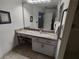 Bright bathroom with granite countertop, vanity, and large mirror at 8623 Sw 108Th Place Rd, Ocala, FL 34481