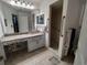 Main bathroom with granite vanity, walk-in shower, and grab bars at 8623 Sw 108Th Place Rd, Ocala, FL 34481