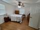 Comfortable bedroom with hardwood floors, a ceiling fan, and ample closet space at 8623 Sw 108Th Place Rd, Ocala, FL 34481