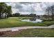 Landscaped golf course with pond and walking path at 8623 Sw 108Th Place Rd, Ocala, FL 34481