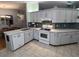 Modern kitchen featuring white cabinets, quartz countertops, and tile backsplash at 8623 Sw 108Th Place Rd, Ocala, FL 34481