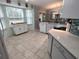 Bright kitchen with tile flooring, white cabinets, and stainless steel appliances at 8623 Sw 108Th Place Rd, Ocala, FL 34481