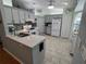 Modern kitchen with white cabinets, quartz countertops, and tiled floors at 8623 Sw 108Th Place Rd, Ocala, FL 34481