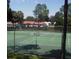 Community tennis courts with green surface and fencing at 8623 Sw 108Th Place Rd, Ocala, FL 34481