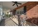 Covered porch with ceiling fan and gray chairs at 8671 Sw 97Th St # C, Ocala, FL 34481