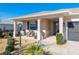 Covered porch with wicker chairs and side yard landscaping at 8878 Sw 103Rd Cir, Ocala, FL 34481