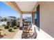 Covered porch with wicker rocking chairs and view of neighborhood at 8878 Sw 103Rd Cir, Ocala, FL 34481