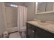 Simple bathroom with a shower/tub combo and dark vanity at 11001 Se Sunset Harbor Rd # E 33, Summerfield, FL 34491