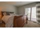 Comfortable bedroom featuring sliding glass doors to private balcony and neutral color scheme at 11001 Se Sunset Harbor Rd # E 33, Summerfield, FL 34491