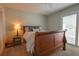 Inviting bedroom showcasing a comfortable bed and sliding glass door to a private balcony at 11001 Se Sunset Harbor Rd # E 33, Summerfield, FL 34491