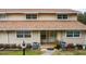 Inviting townhouse exterior featuring neutral siding, updated roof, and well-maintained landscaping at 11001 Se Sunset Harbor Rd # E 33, Summerfield, FL 34491