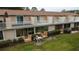 Townhome exterior with private balconies, patios, and well-manicured green spaces at 11001 Se Sunset Harbor Rd # E 33, Summerfield, FL 34491