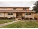 Cozy townhome featuring a well-maintained lawn and classic siding at 11001 Se Sunset Harbor Rd # E 33, Summerfield, FL 34491
