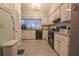 Bright kitchen with appliances, ample cabinet space, and tile flooring at 11001 Se Sunset Harbor Rd # E 33, Summerfield, FL 34491