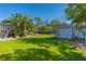 Landscaped backyard with storage shed and lush greenery at 11418 Lake Eustis Dr, Leesburg, FL 34788