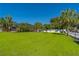 Large grassy backyard with a screened pool and play area at 11418 Lake Eustis Dr, Leesburg, FL 34788