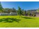 Spacious backyard with lush lawn, storage shed, and fire pit area at 11418 Lake Eustis Dr, Leesburg, FL 34788