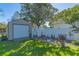 Charming backyard with storage shed, garden, and decorative accents at 11418 Lake Eustis Dr, Leesburg, FL 34788