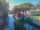 Covered boat dock with lift for easy access to the waterway at 11418 Lake Eustis Dr, Leesburg, FL 34788