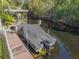 Private boat dock with covered boat lift on calm water at 11418 Lake Eustis Dr, Leesburg, FL 34788