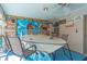 Covered patio features a boat, seating, and nautical decor at 11418 Lake Eustis Dr, Leesburg, FL 34788