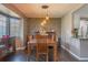 Dining room with stone accent wall and wooden table at 11418 Lake Eustis Dr, Leesburg, FL 34788