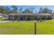 Brick ranch-style home with a spacious lawn at 11418 Lake Eustis Dr, Leesburg, FL 34788