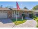 Brick front exterior with paver walkway and American flag at 11418 Lake Eustis Dr, Leesburg, FL 34788