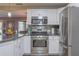 Stainless steel appliances and granite countertops in this kitchen at 11418 Lake Eustis Dr, Leesburg, FL 34788