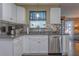 White kitchen cabinets, stainless steel appliances, and granite countertops at 11418 Lake Eustis Dr, Leesburg, FL 34788