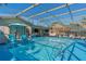 Screened pool area with lounge chairs and patio furniture at 11418 Lake Eustis Dr, Leesburg, FL 34788