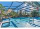 Relaxing screened pool and patio with lounge chairs at 11418 Lake Eustis Dr, Leesburg, FL 34788