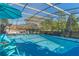 Inviting screened pool with patio furniture and umbrellas at 11418 Lake Eustis Dr, Leesburg, FL 34788