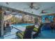 Covered patio with pool view, comfortable seating, and bar area at 11418 Lake Eustis Dr, Leesburg, FL 34788