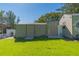 Two storage sheds with concrete pads in the backyard at 11418 Lake Eustis Dr, Leesburg, FL 34788