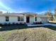 Newly built home with light-colored siding, landscaping, and a two-car garage at 12314 Se 104Th Ter, Belleview, FL 34420