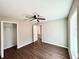 Bright bedroom with wood-look floors, ceiling fan and walk-in closet at 12322 Se 104Th Ter, Belleview, FL 34420