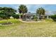 Expansive backyard featuring mature trees, a screened lanai, and ample green space at 15715 Sw 11Th Terrace Rd, Ocala, FL 34473